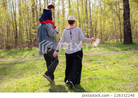 Grandfather, grandmother and grandson are having fun outdoors. Grandfather, grandmother and grandson are having fun outdoors. 126332246