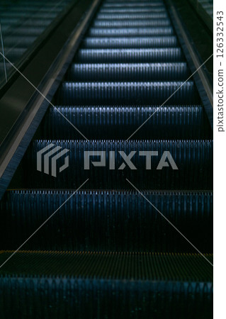 Escalator in a modern shopping center in dark tones 126332543