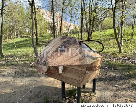 Wooden Boar Sculpture in a Sunny Forest Playground 126332678