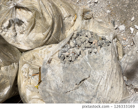 Gravel and Construction Debris Packed in Transparent Bags at Worksite Under Sunlight 126333169