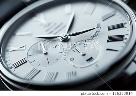 Luxury watch showing time passing by featuring roman numerals 126333914