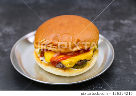 A cheeseburger is on a plate 126334215