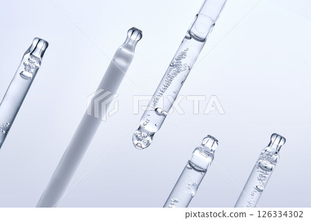 Five different droppers with facial serum in a row. 126334302