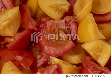 preparation of salad from tomatoes with spices and olive oil, close up 126334802