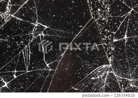 glass broken into many pieces on a dark background 126334810