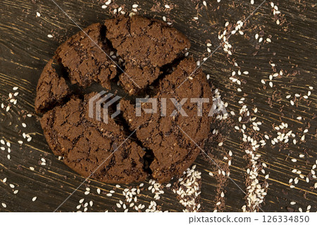 round chocolate biscuits with white sesame seeds and cocoa powder 126334850