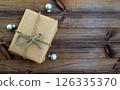 Christmas background. Gift and Christmas balls on a wooden background. 126335370