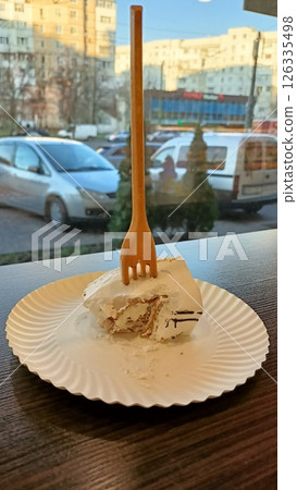 Delightful Dessert A Beautifully Crafted Cake Elegantly Plated with a Rustic Wooden Fork 126335498
