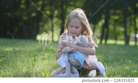 Joyful little girl child portrait in a summer park Joyful little girl child portrait in a summer park 126335825