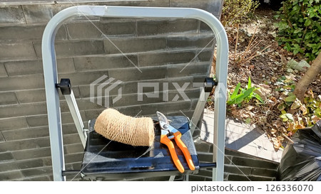 Tools and Various Equipment Placed on a Step Stool in an Outdoor Natural Setting Environment 126336070