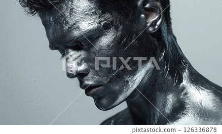 Artistic black body paint portrait capturing profile view in monochromatic style. Dramatic beauty photography showcases textured metallic effect with water droplets on skin Artistic black body paint portrait capturing profile view in monochromatic style. Dramatic beauty photography showcases textured metallic effect with water droplets on skin 126336878