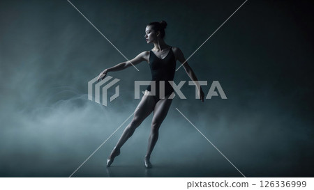 A graceful ballerina in a sleek black leotard strikes a poised pose amid misty stage lighting, embodying elegance, strength, and fluid motion in a dramatic dance performance 126336999
