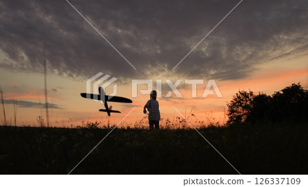 baby girl playing airplane pilot, kid dream flying, kid superhero, Child with toy airplane at sunset, Dreaming of flying, Kid playing outdoors in evening, Silhouette of a boy with plane, Imagining baby girl playing airplane pilot, kid dream flying, kid superhero, Child with toy airplane at sunset, Dreaming of flying, Kid playing outdoors in evening, Silhouette of a boy with plane, Imagining 126337109