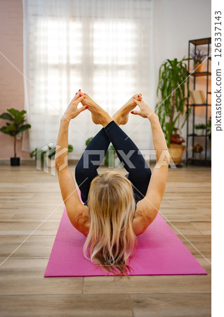 Yoga practice in a serene indoor studio with natural light Yoga practice in a serene indoor studio with natural light 126337143