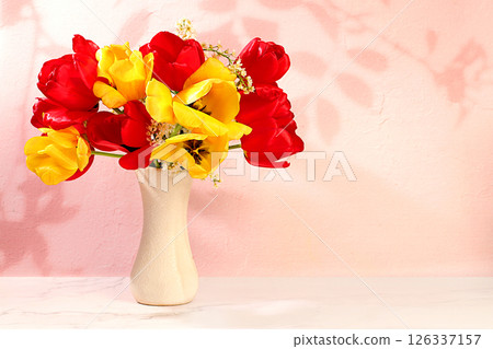 Abstract flower arrangement and banner for screen, Still life,Beautiful spring blooming tulips and cherries in vase on elegant background. Floral holiday card with summer greeting concept Abstract flower arrangement and banner for screen, Still life,Beautiful spring blooming tulips and cherries in vase on elegant background. Floral holiday card with summer greeting concept 126337157