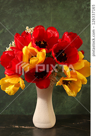 Abstract floral arrangement and banner for screen, Still life with beautiful spring branches of blooming bird cherry,cherry and tulips in vase on elegant background.Floral holiday card with summer Abstract floral arrangement and banner for screen, Still life with beautiful spring branches of blooming bird cherry,cherry and tulips in vase on elegant background.Floral holiday card with summer 126337165