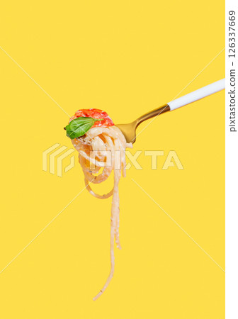 Fork with creamy spaghetti, tomato and basil on isolated bright yellow background. Fork with creamy spaghetti, tomato and basil on isolated bright yellow background. 126337669