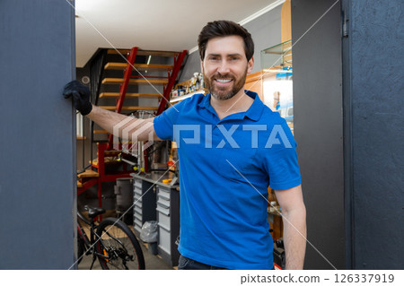 Mechanic standing casually in workshop Mechanic standing casually in workshop 126337919