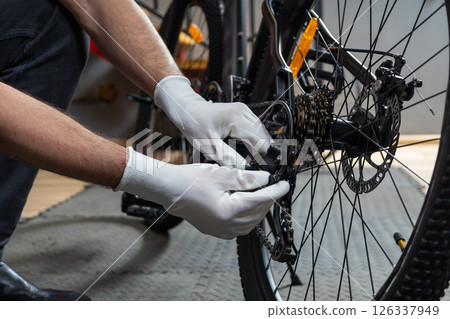 Mechanic polishing bike wheel Mechanic polishing bike wheel 126337949
