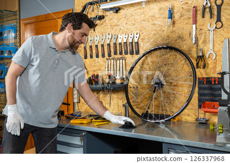 Mechanic in white gloves holding wheel 126337968