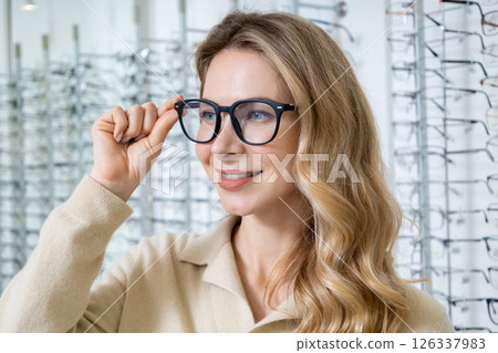 Pretty blonde caucasian woman in eyeglasses smiling nicely Pretty blonde caucasian woman in eyeglasses smiling nicely 126337983