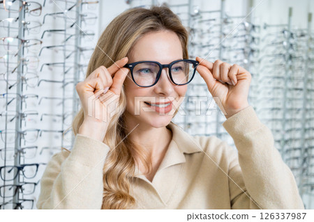 Pretty blonde caucasian woman in eyeglasses smiling nicely 126337987