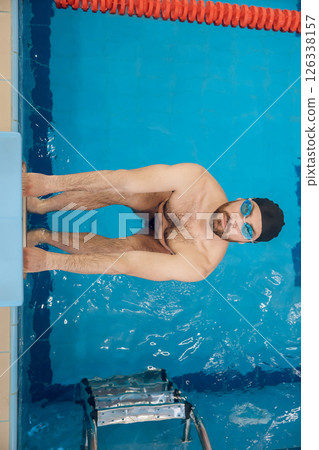Man in swimming glasses having a workout in the pool Man in swimming glasses having a workout in the pool 126338157
