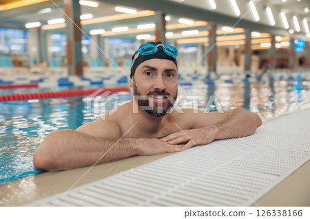 Handsome caucasian man spending time in the swimming pool Handsome caucasian man spending time in the swimming pool 126338166