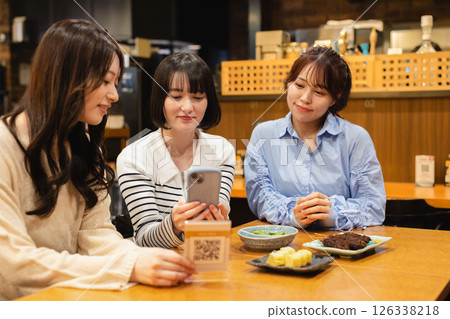 A woman ordering via mobile 126338218