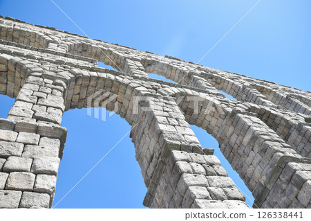 Tilted bottom view of Segovia Aqueduct, Roman construction for transporting water Tilted bottom view of Segovia Aqueduct, Roman construction for transporting water 126338441