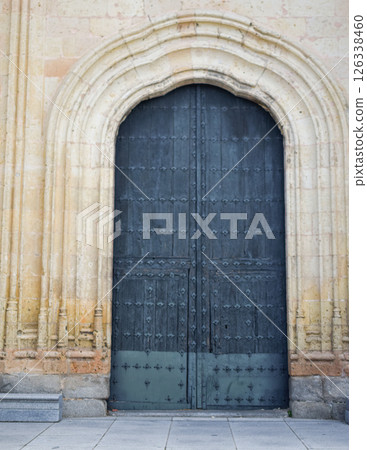 View of a large front door of a Gothic cathedral in Segovia. View of a large front door of a Gothic cathedral in Segovia. 126338460