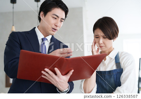 A real estate salesman showing a property and a woman opening a business A real estate salesman showing a property and a woman opening a business 126338507