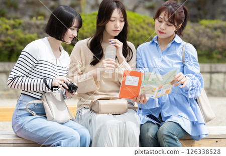 A woman looking at a guide map 126338528