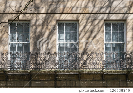 A stunning view of Leazes Terrace is an elongated square of houses with Wrought iron black railings balconies and Glass windows in Newcasle. A stunning view of Leazes Terrace is an elongated square of houses with Wrought iron black railings balconies and Glass windows in Newcasle. 126339549