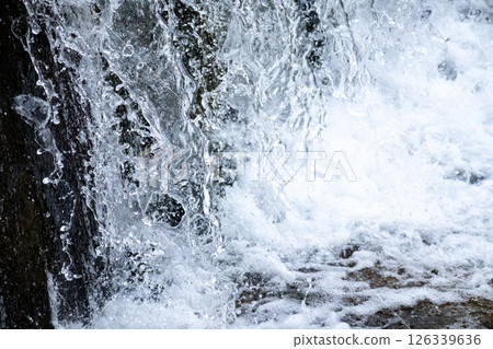 Falling water close-up and black background 126339636