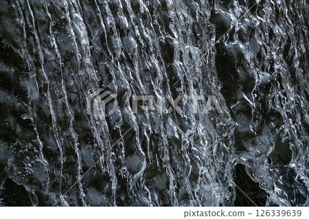 Falling water close-up and black background 126339639