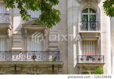 Architecture splendour of Traditional French residential tenement building with Traditional French Shutters & Windows and wrought iron black railings balconies. 126339649