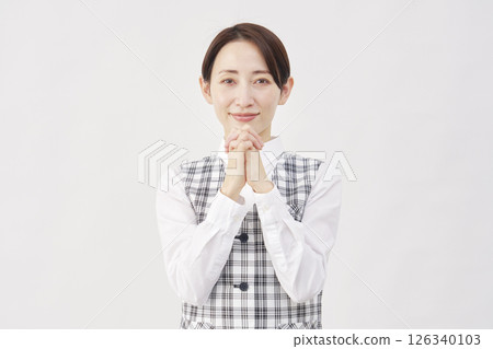 Female office worker praying, white background, looking at camera 126340103