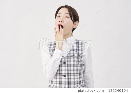 Female office worker yawning white background 126340104