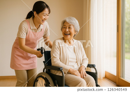A caregiver in a room with natural light streaming in 126340549