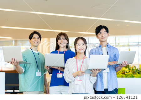 Young engineers working in an office. Photo courtesy of Denpa Gakuen, Tokyo Electronics College. 126341121