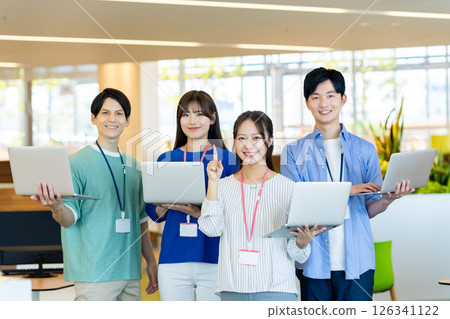 Young engineers working in an office. Photo courtesy of Denpa Gakuen, Tokyo Electronics College. 126341122