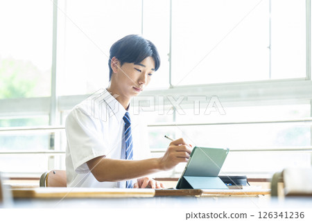 High school boy studying on a tablet 126341236
