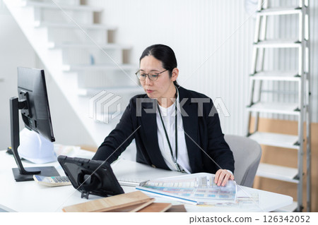 A female architect operating a tablet A female architect operating a tablet 126342052