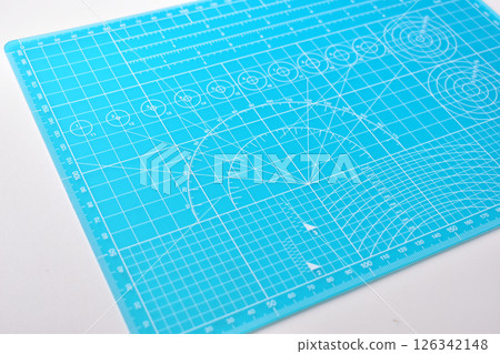 blue cutting mat board on white background with line and scale measure guide pattern for art design 126342148