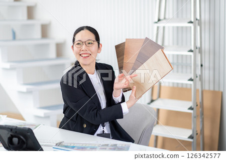 A woman explaining with building material samples A woman explaining with building material samples 126342577