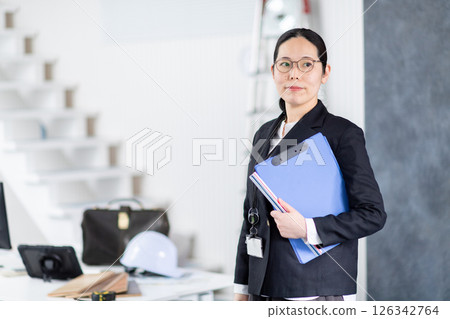 Female employee of a construction company 126342764