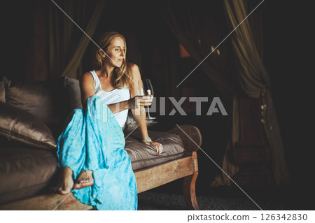 Young woman sit on sofa inside luxury wooden villa. Girl relaxing on family summer vacation. Tropical lifestyle. Young woman sit on sofa inside luxury wooden villa. Girl relaxing on family summer vacation. Tropical lifestyle. 126342830