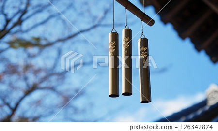 Wind chimes swaying in the wind Wind chimes swaying in the wind 126342874
