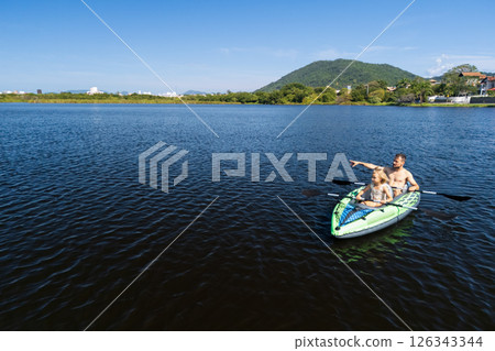 Happy active family with kids have a fun on kayak in sea lagoon.  Healthy lifestyle. Recreational water sport, outdoors activities, kayaking tour in adventure camp on family summer beach vacation 126343344